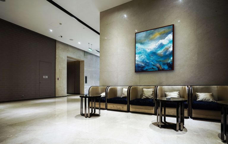 A painting by Andy Taylor (Brightwater) Blue and turqouise sea scape in a corporate lobby
